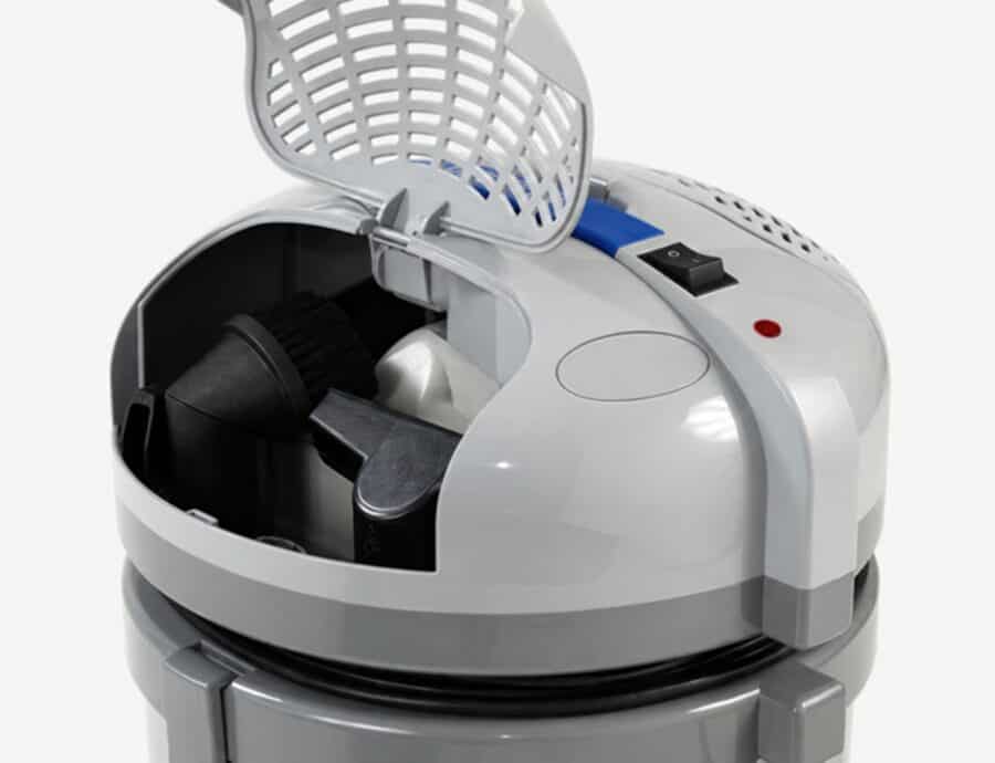 Open onboard storage compartment with cleaning tools inside the professional vacuum cleaner