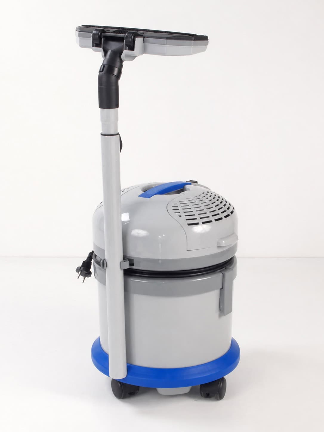 Rear view of the vacuum cleaner with telescopic wand and floor tool stored on the machine