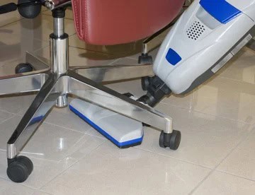Universal vacuum floor tool being used beneath seating