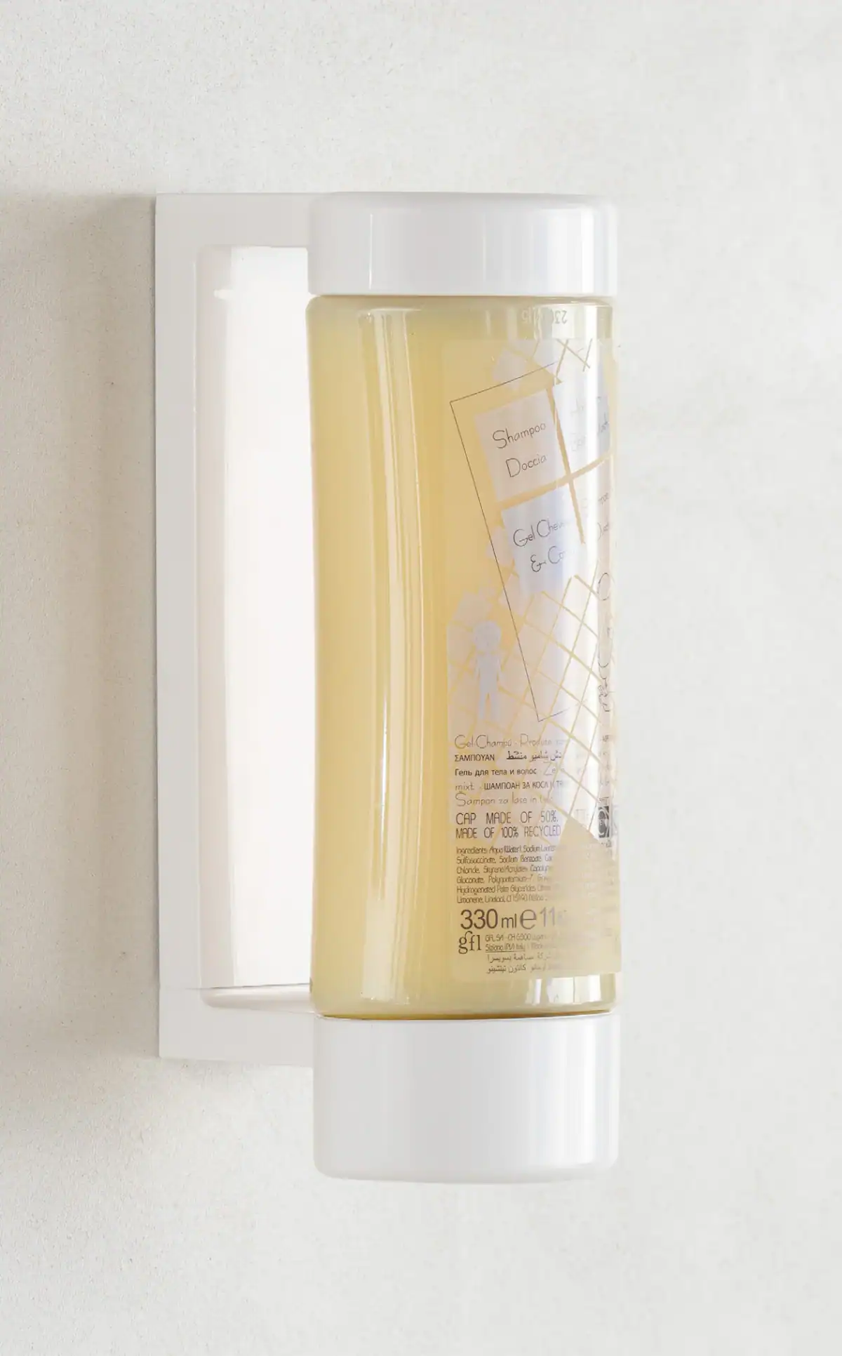 Wall-mounted Neutra hair and body wash dispenser on a light surface